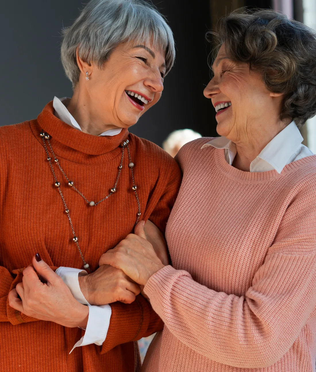 Two older friends laughing together
